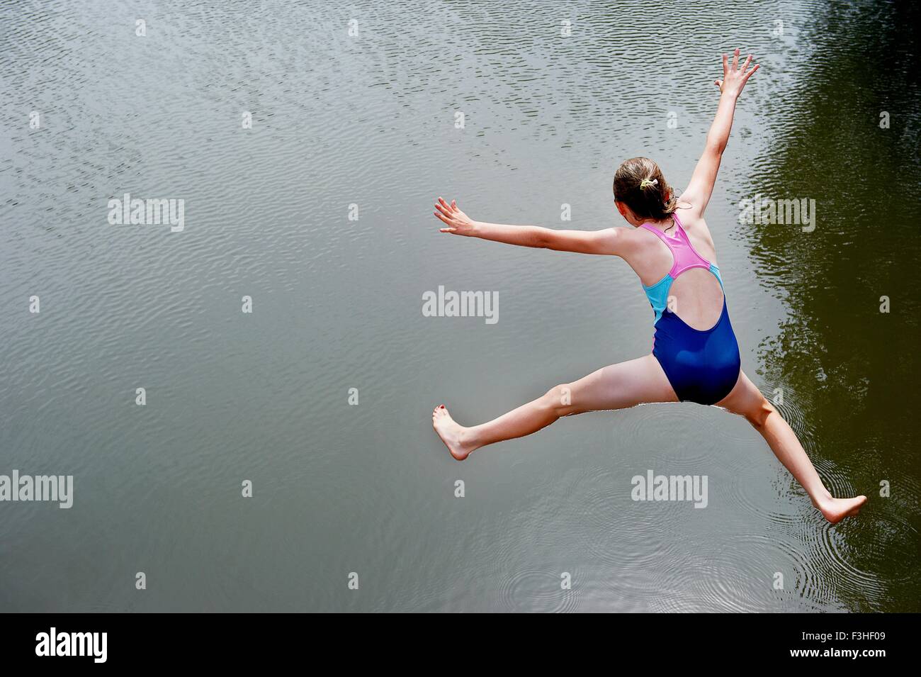 Vista aérea de la niña saltando en el lago Foto de stock