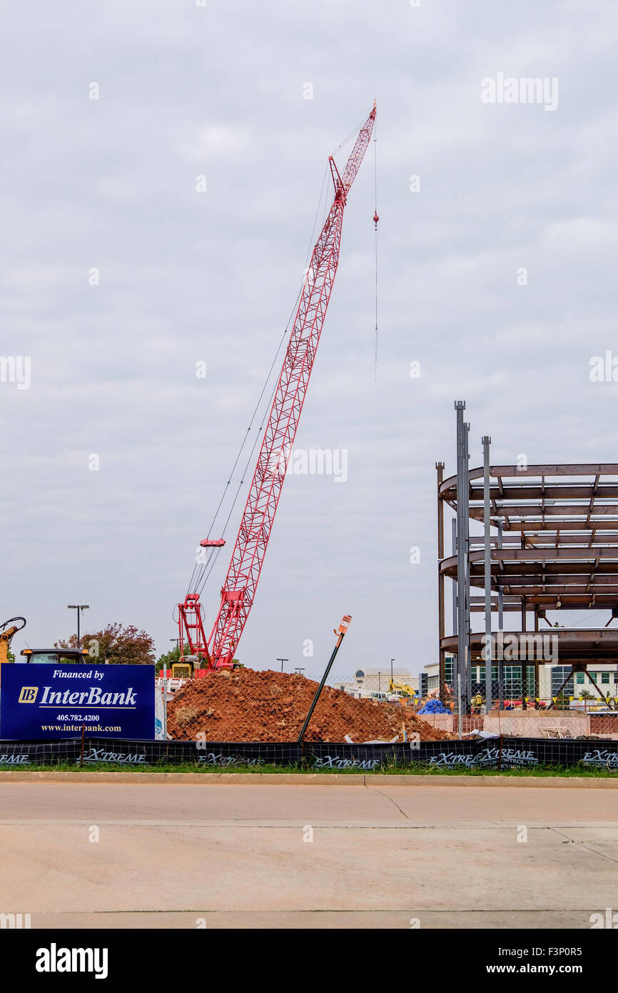 Una grúa está junto a marco de acero para un edificio comercial en el proceso de construcción en la Ciudad de Oklahoma, Oklahoma, Estados Unidos. Foto de stock