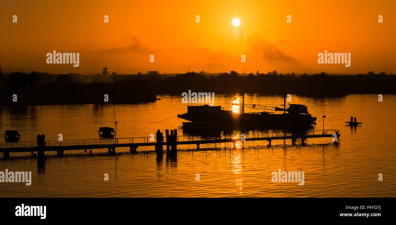 Sunset Jetty silueta cielo anaranjado por el mar de la naturaleza Foto de stock