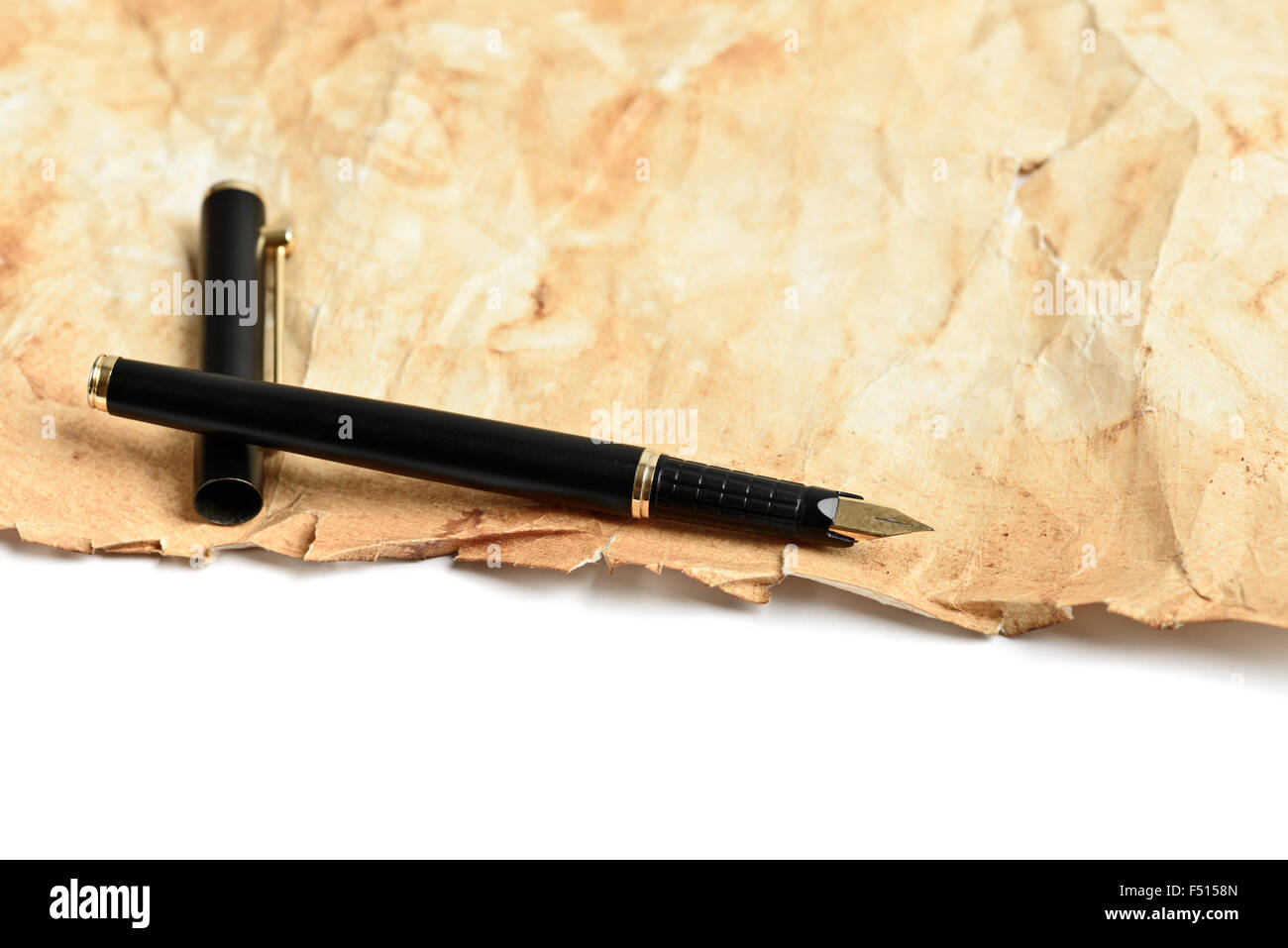 Elegante bolígrafo de tinta dorada sobre papel antiguo grunge Foto de stock