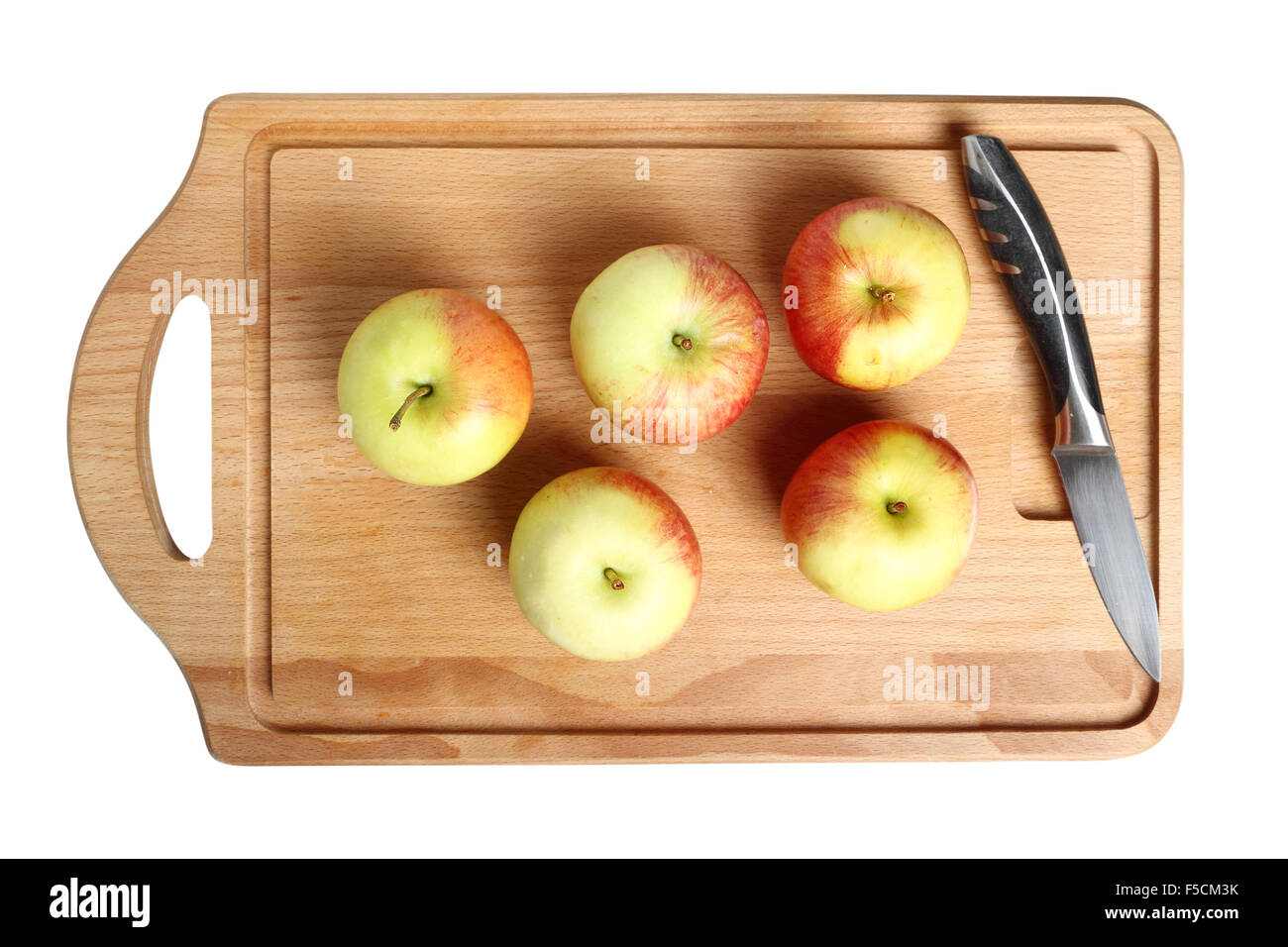 Manzanas en placa de corte Foto de stock