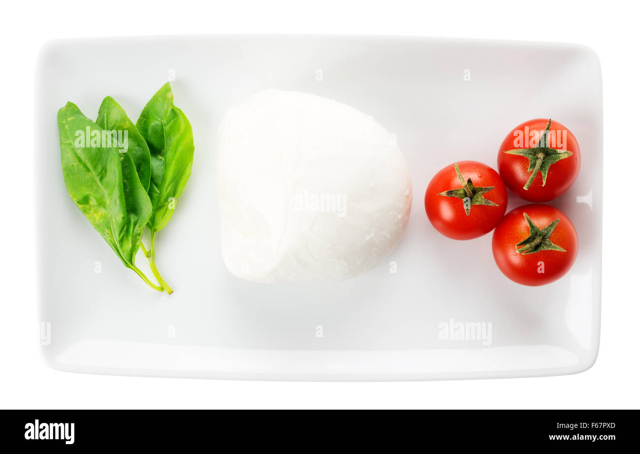 Comida italiana verde blanco rojo bandera italiana, albahaca mozzarella tomate vajilla rectangular aislado sobre fondo blanco. Foto de stock