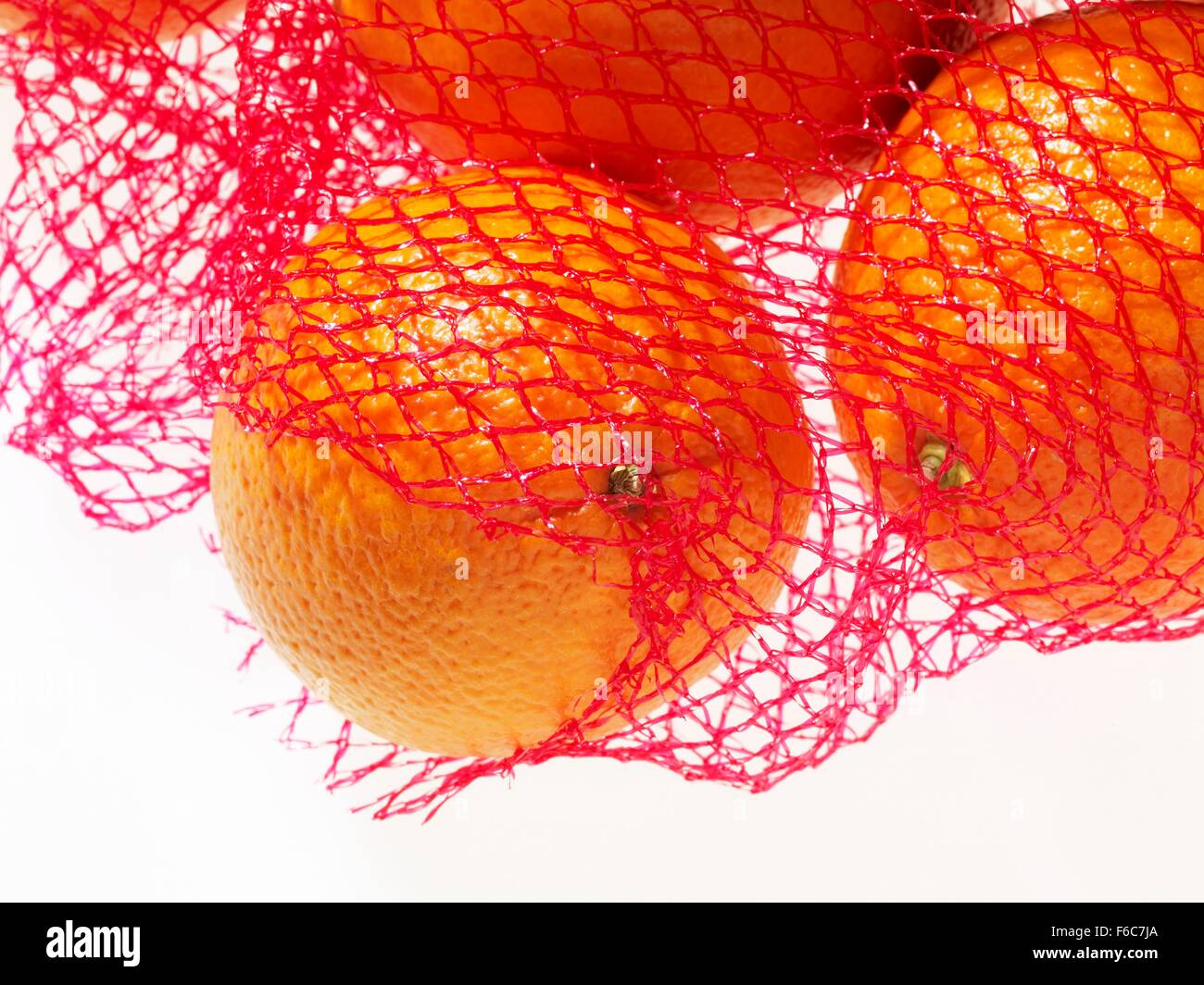 Las naranjas en una red (cerrar) Foto de stock