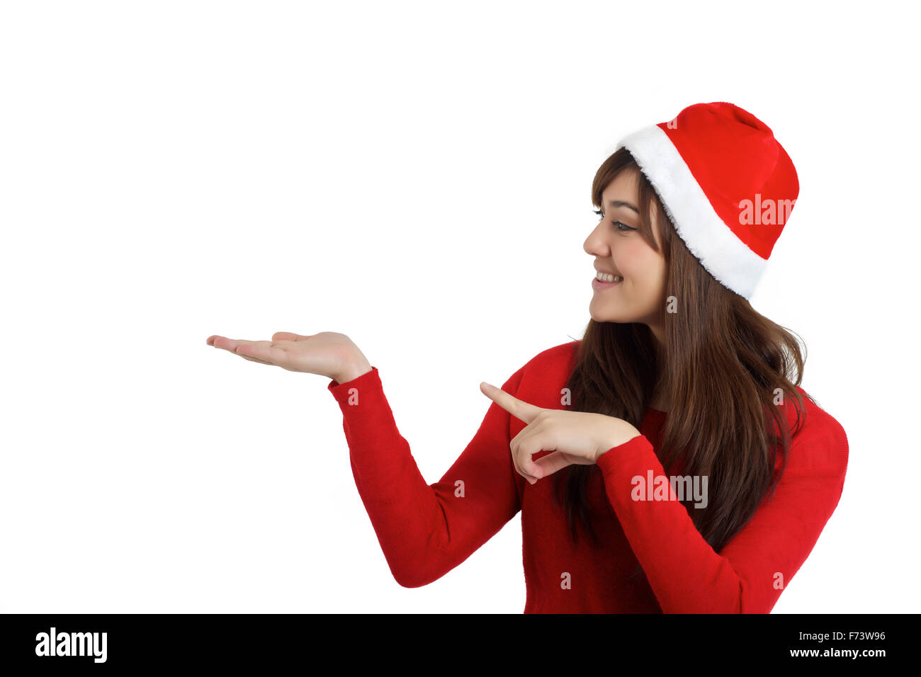 Santa Claus Navidad Mujer señalando producto sobre fondo blanco. Foto de stock