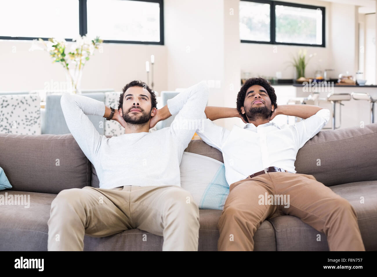 Feliz pareja gay relajándose en el sofá Foto de stock