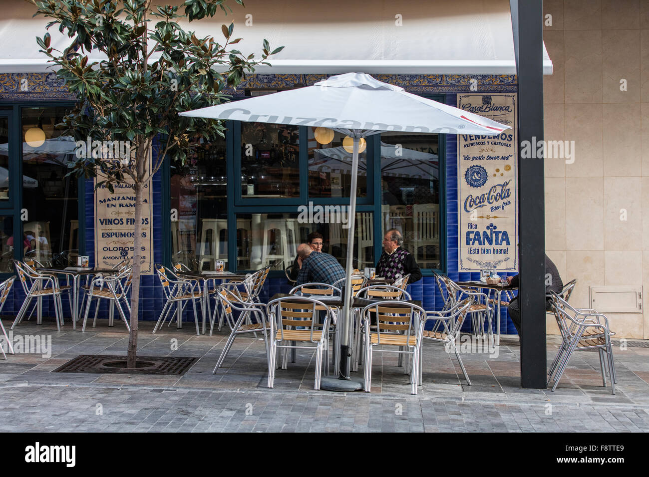 Fuera de un bar muy agradable en Marbella con clientes sentado fuera en una  mesa con sillas Fotografía de stock - Alamy