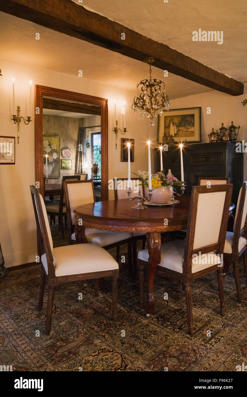 Mesa ovalada de madera antigua y sillas tapizadas en el Mesa ovalada de madera antigua y sillas tapizadas en el