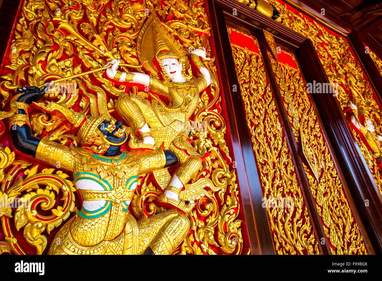 Talla de madera del Ramayana épico sobre la pared del Templo - Samut Songkhram, Tailandia Foto de stock