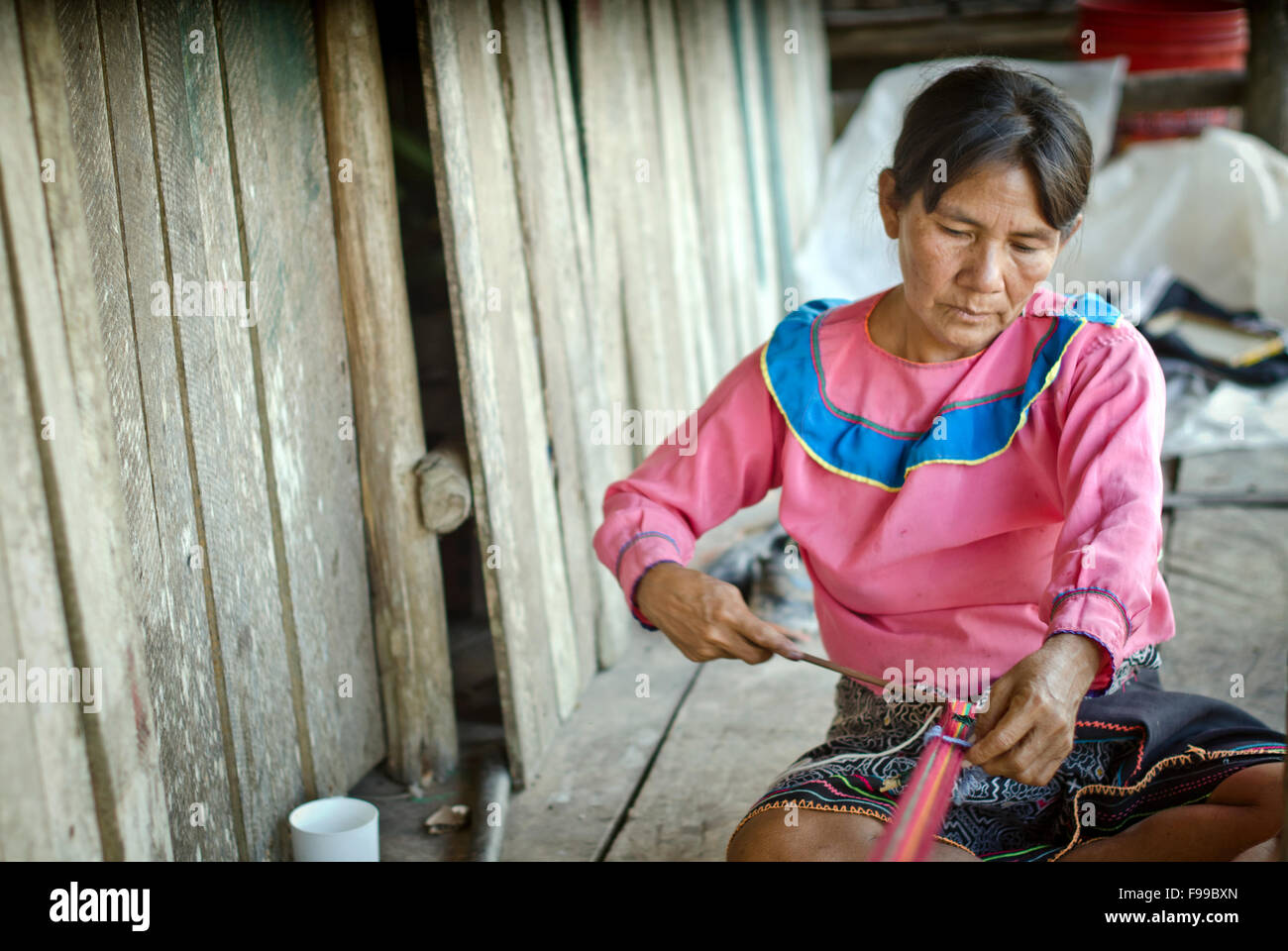 Mujer tejiendo,Charashmana, Shipibo tribu remota aldea en un río Pisqui ,selva Amazónica Perú Foto de stock