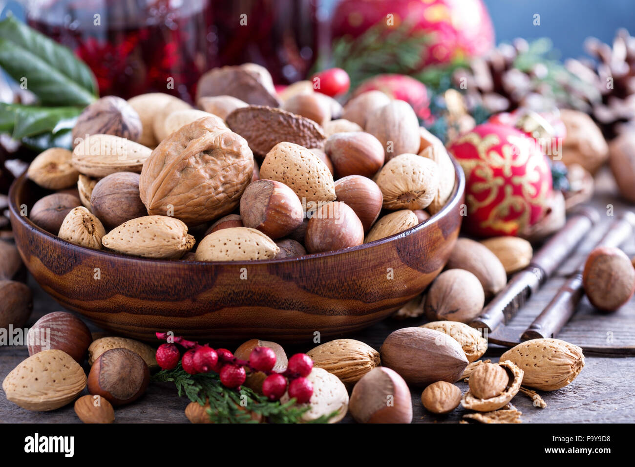 Variedad de nueces con cáscara en un recipiente marrón Foto de stock