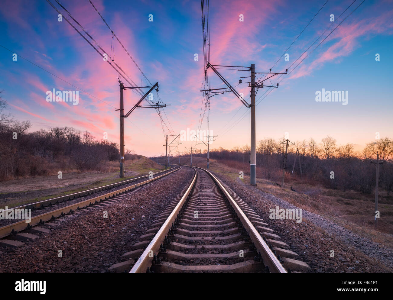 Plataforma de tren al atardecer. Ferrocarril en Ucrania. Paisaje de ferrocarril. Foto de stock