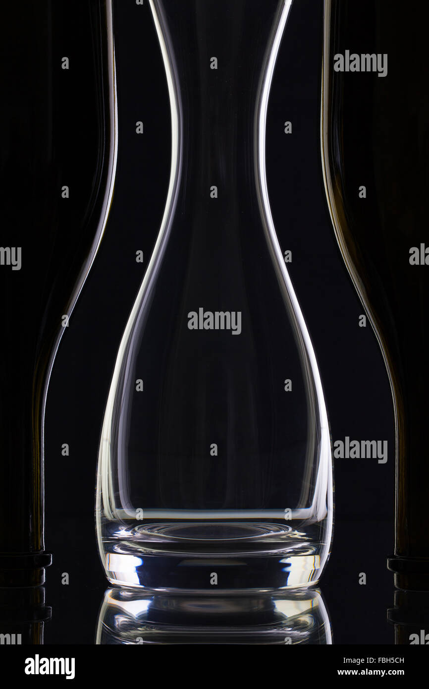 Vidrio y botellas vacías en el fondo negro Foto de stock