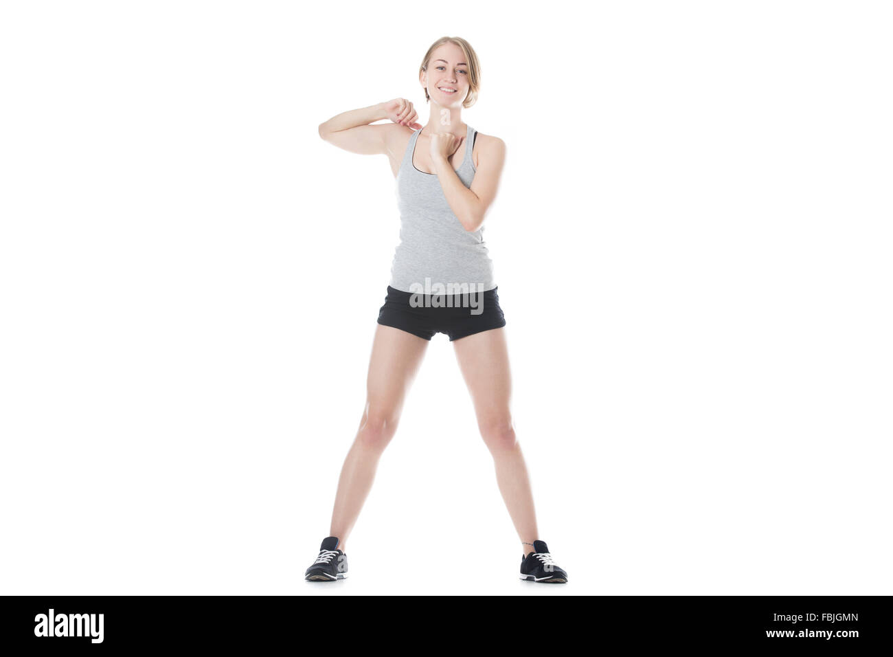 Slim joven mujer hermosa calentamiento antes de trabajar, haciendo  ejercicios para brazos y hombros, longitud completa aislado studio  Fotografía de stock - Alamy