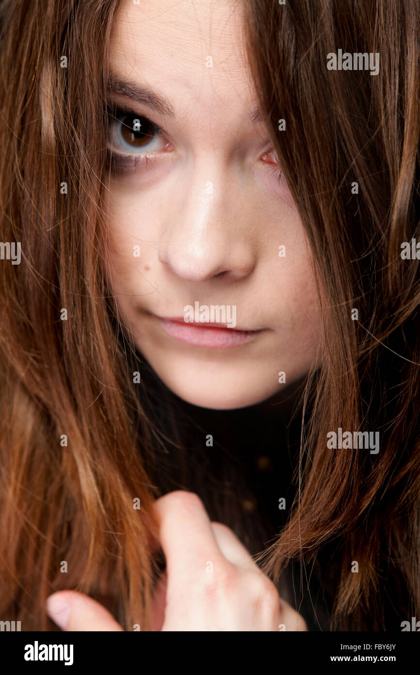 Closeup mujer cubre el rostro por largos pelos marrones Foto de stock