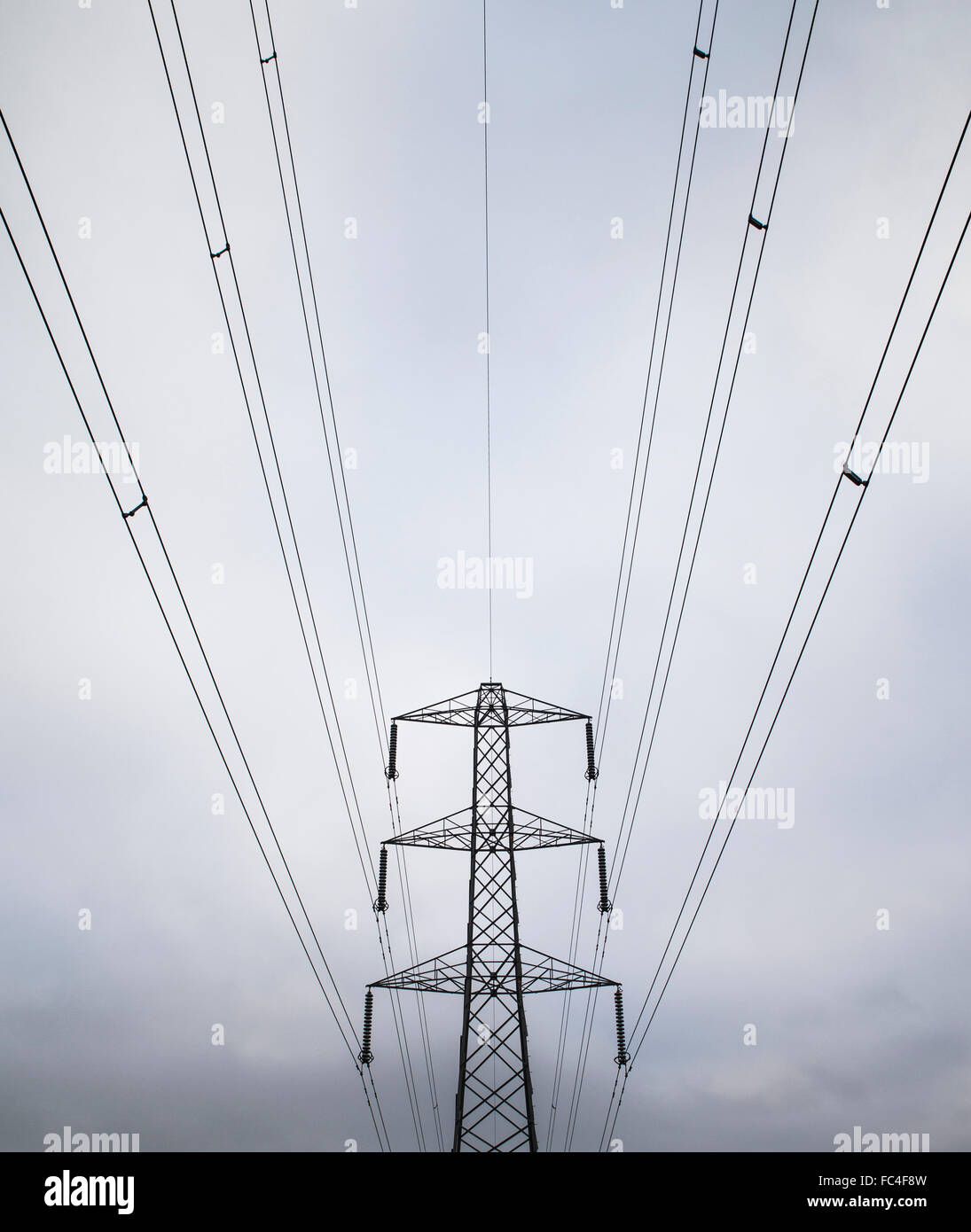 Poderosa imagen de cables eléctricos que conducen a un gran, metal, National Grid pilón. Foto de stock