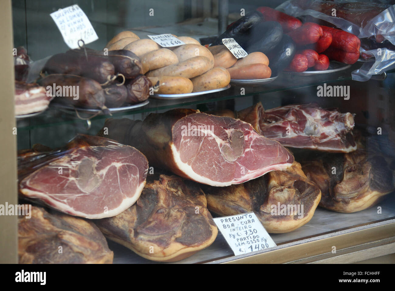 Productos de carne de cerdo en la pantalla en una tienda en la ciudad portuguesa de Oporto Foto de stock