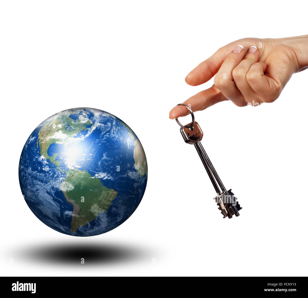 La mano que sujeta las llaves de todo el mundo. Collage. Foto de stock