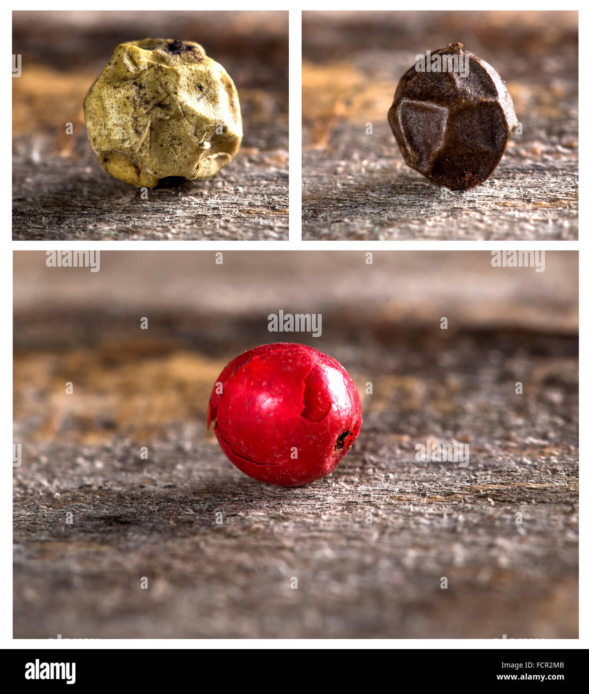 Tres granos de pimienta: negro, blanco y rojo sobre fondo de madera Foto de stock