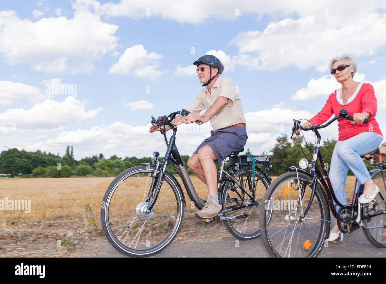 Personas mayores activas atractivo viaje en bicicleta en primavera verano otoño otoño Foto de stock