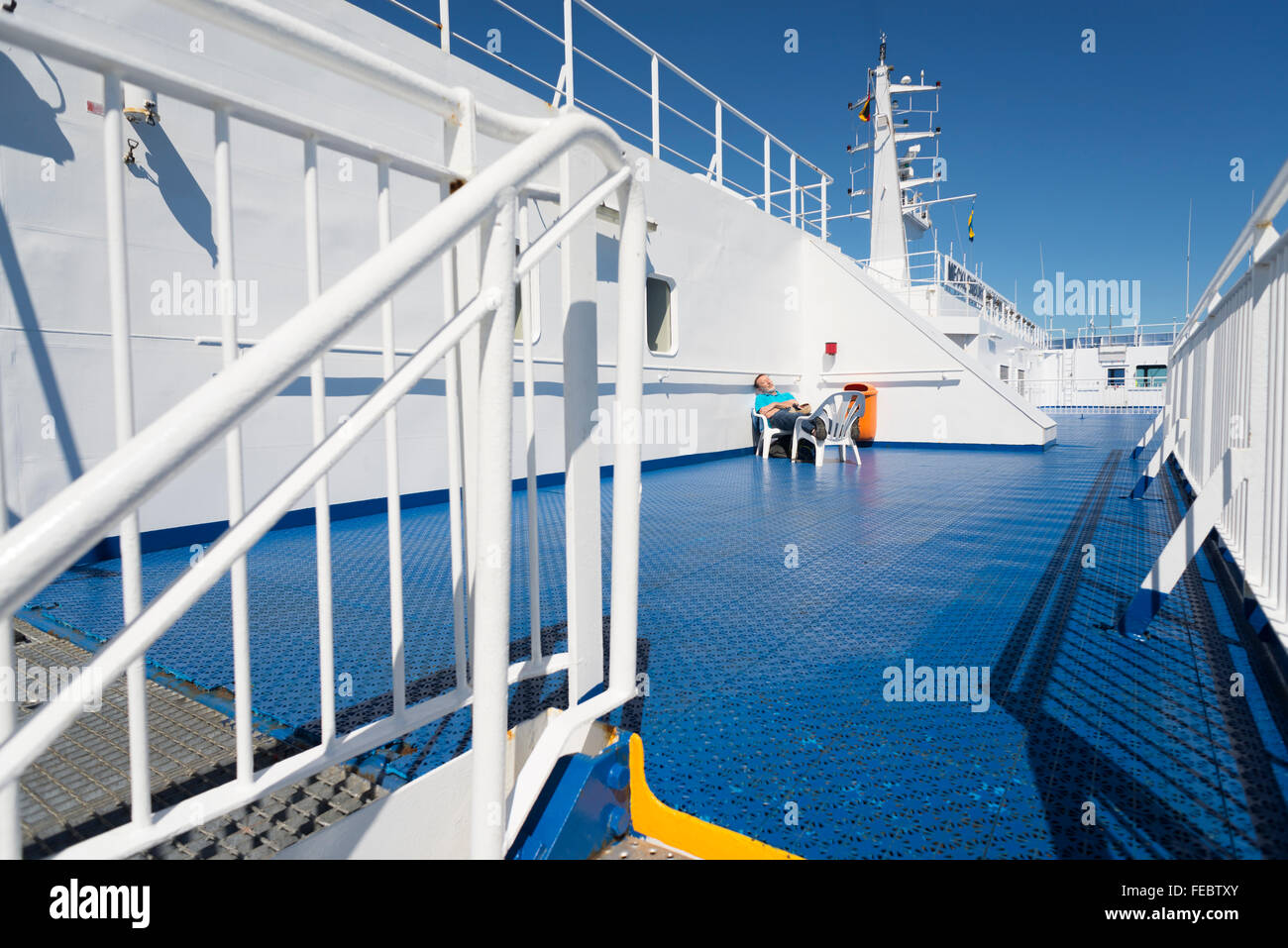 Hombres de pasajeros tomando el sol en la cubierta del buque en el Mar Báltico en verano, en el viaje desde Alemania a Suecia Foto de stock