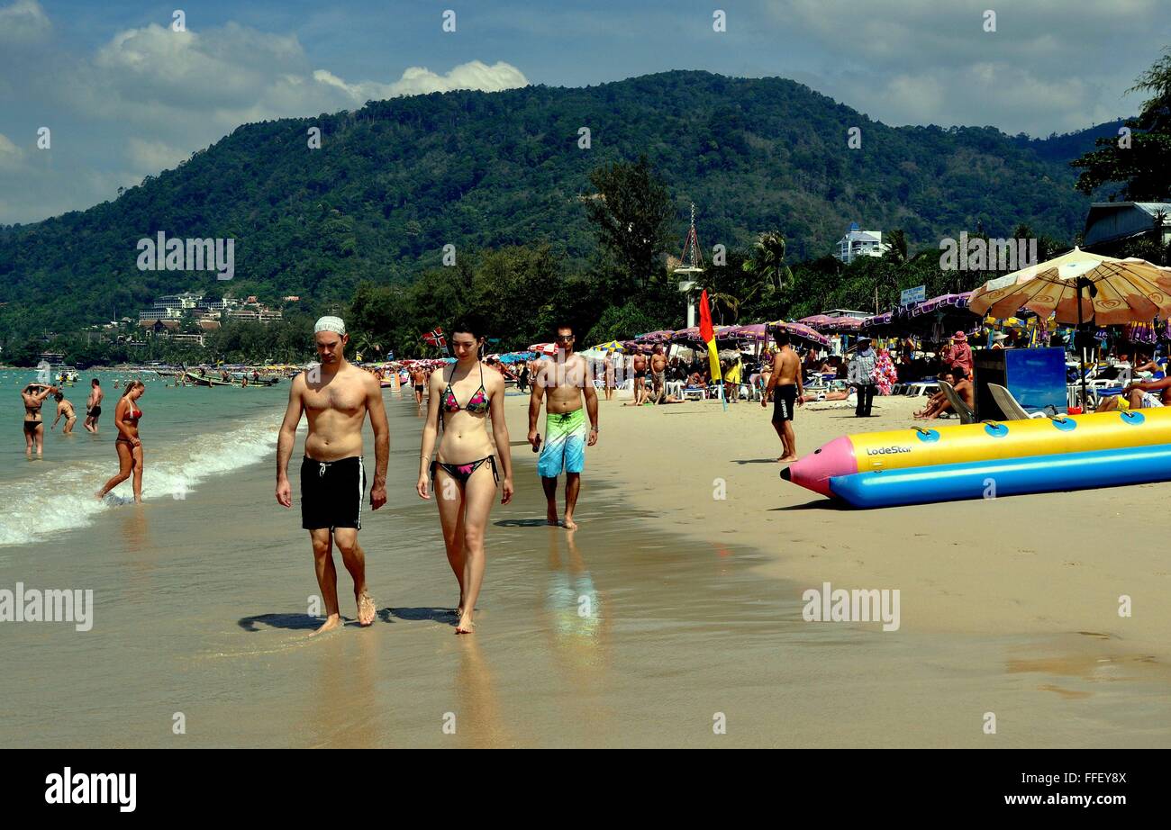 Phuket, Tailandia: turistas paseando por prístina playa Patong Beach, con su arena blanca del Mar Andaman. Foto de stock