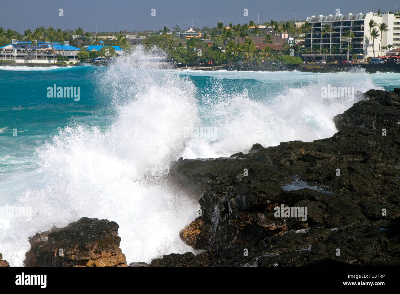 Las olas rompen a lo largo de la costa rocosa en Kailua-Kona, en la Isla Grande de Hawaii, EE.UU. Foto de stock