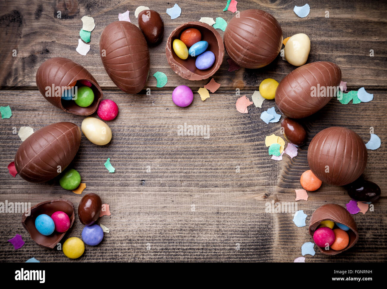 Delicioso chocolate huevos de pascua y dulces sobre fondo de madera Foto de stock
