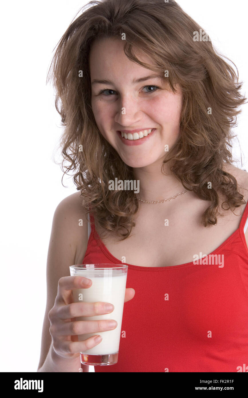 Adolescente sosteniendo un vaso de leche sobre fondo blanco. Foto de stock