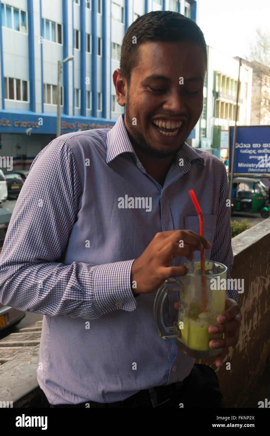 Oficina de Sri Lanka trabajador disfrutar de zumos de fruta fresca, Colombo Foto de stock