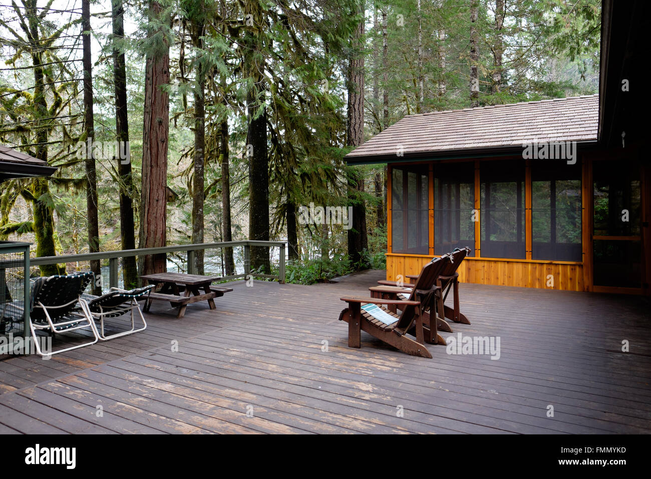 Pantalla habitación en una cabaña de vacaciones junto a una amplia terraza  con sillas Adirondack de madera Fotografía de stock - Alamy