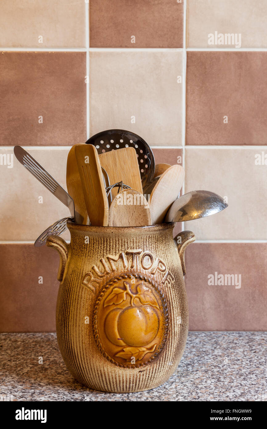 Una vieja jarra rumtopf utilizada como utensilio de cocina almacenamiento sobre una encimera de granito Foto de stock