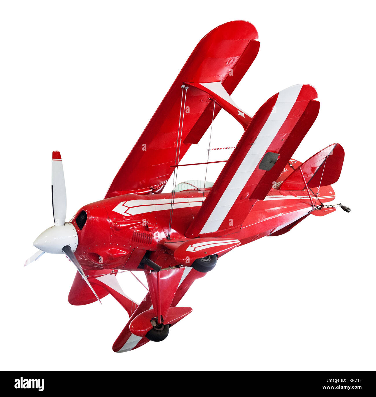 Vintage rojo y blanco bi-plane aislado en blanco posicionado como si la banca en vuelo Foto de stock