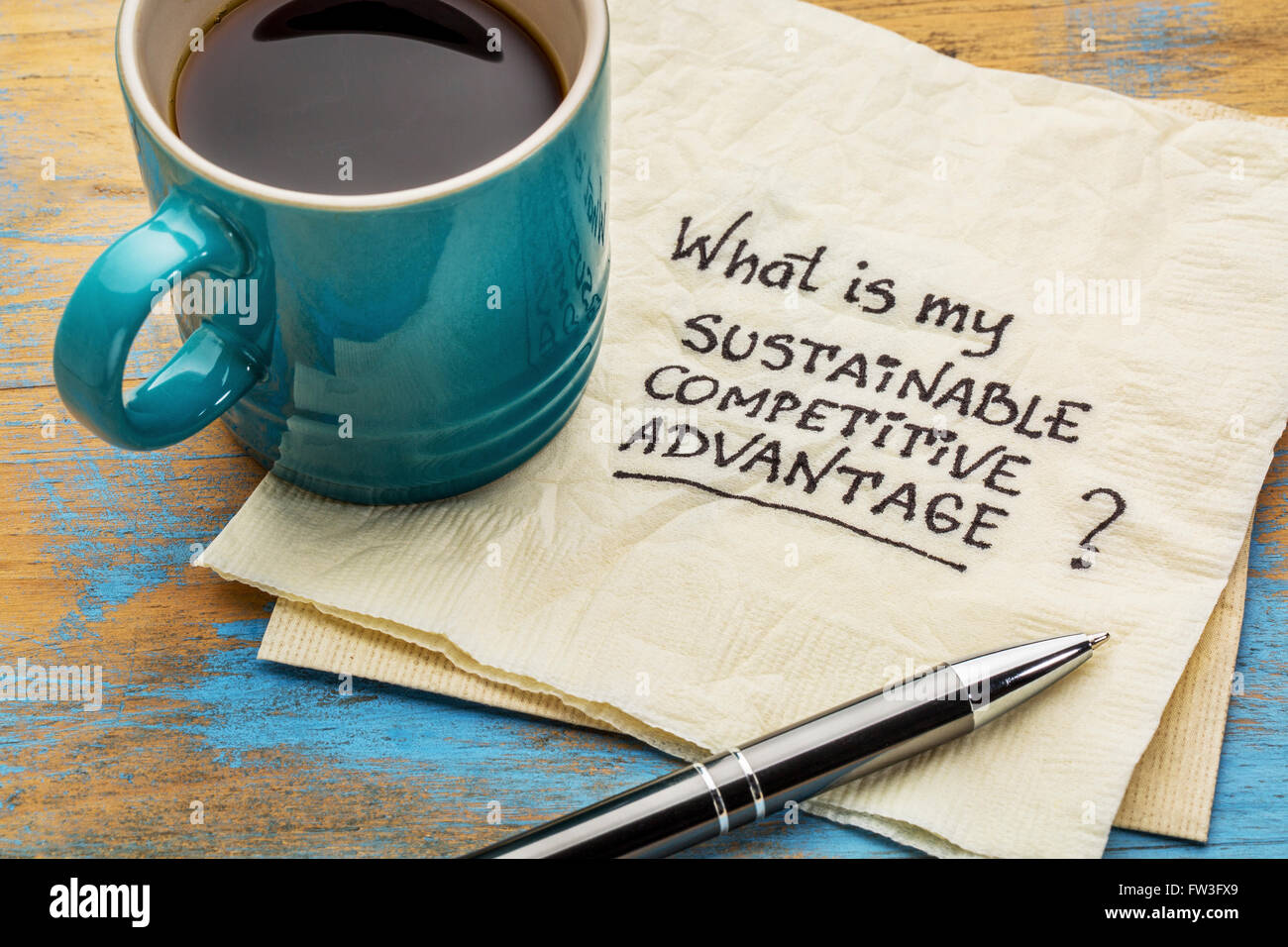 ¿Cuál es mi ventaja competitiva sostenible pregunta - escritura en una servilleta con una taza de café Foto de stock
