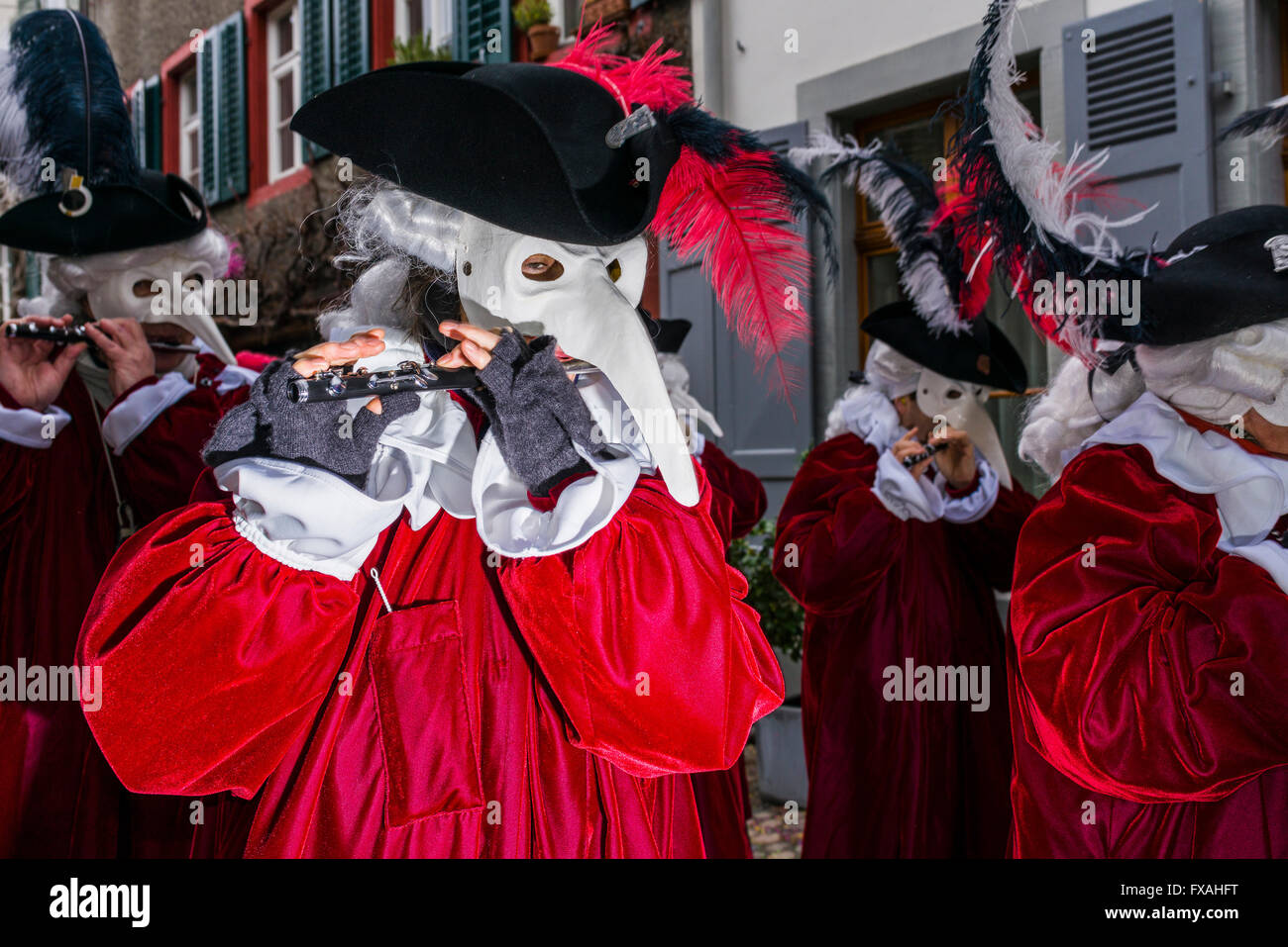 Muchos grupos diferentes de gente enmascarada caminando por las calles de la ciudad de Basilea, 3 días y noches, Basler Fasnacht, tocando música Foto de stock