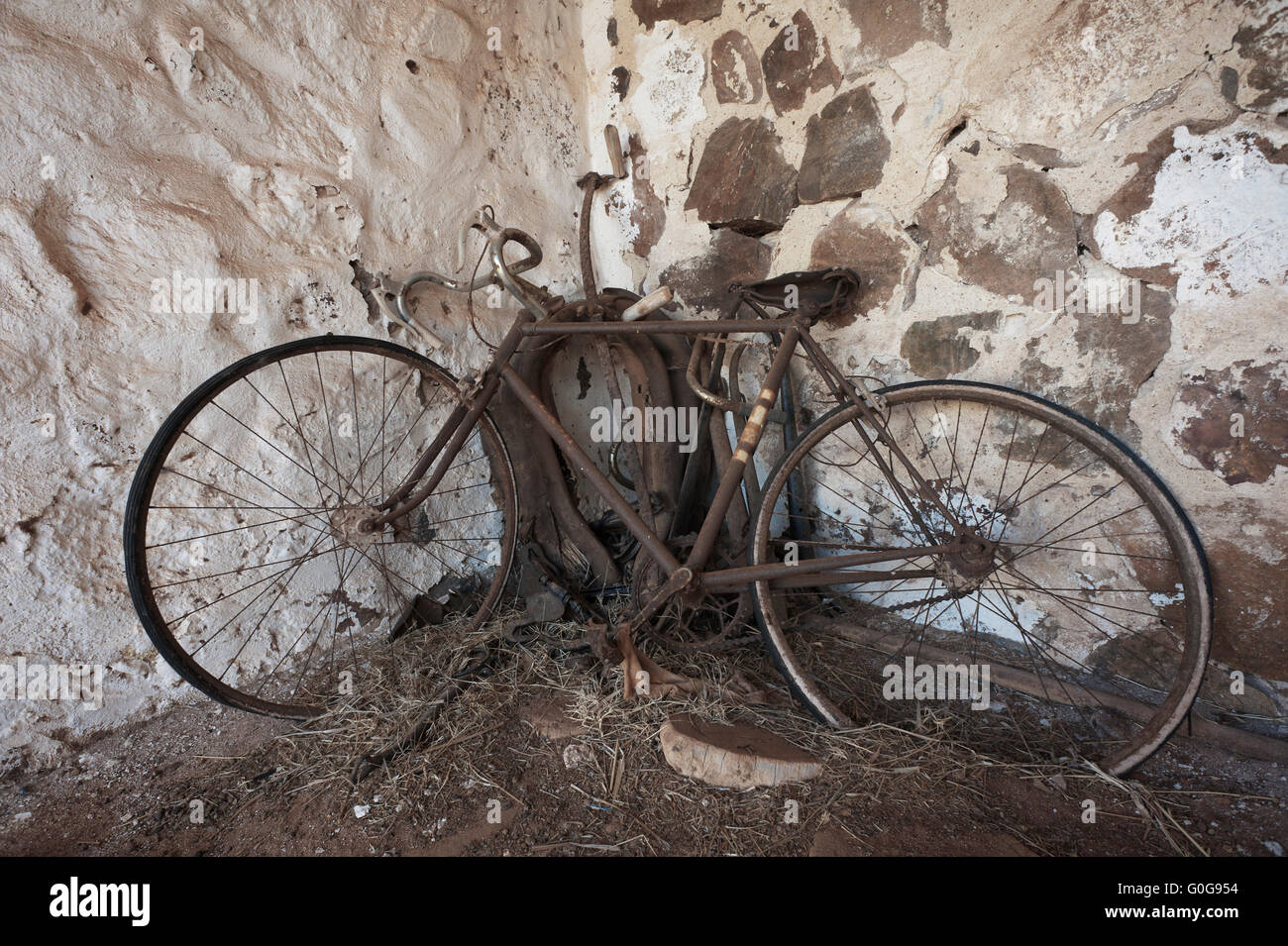 vieja bicicleta oxidada en la esquina de un antiguo de piedra de stock - Alamy