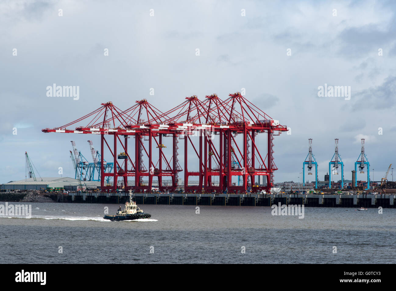 La Svitzer Milford Tug pasando el cinco, el chino construido, grúas