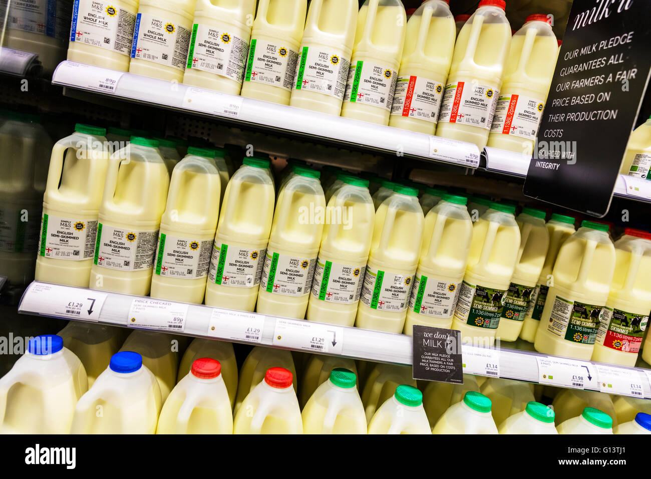 Botellas de leche en la estantería del supermercado en pantalla llena de grasa en la leche desnatada Marks & Spencer muestra UK Inglaterra Foto de stock