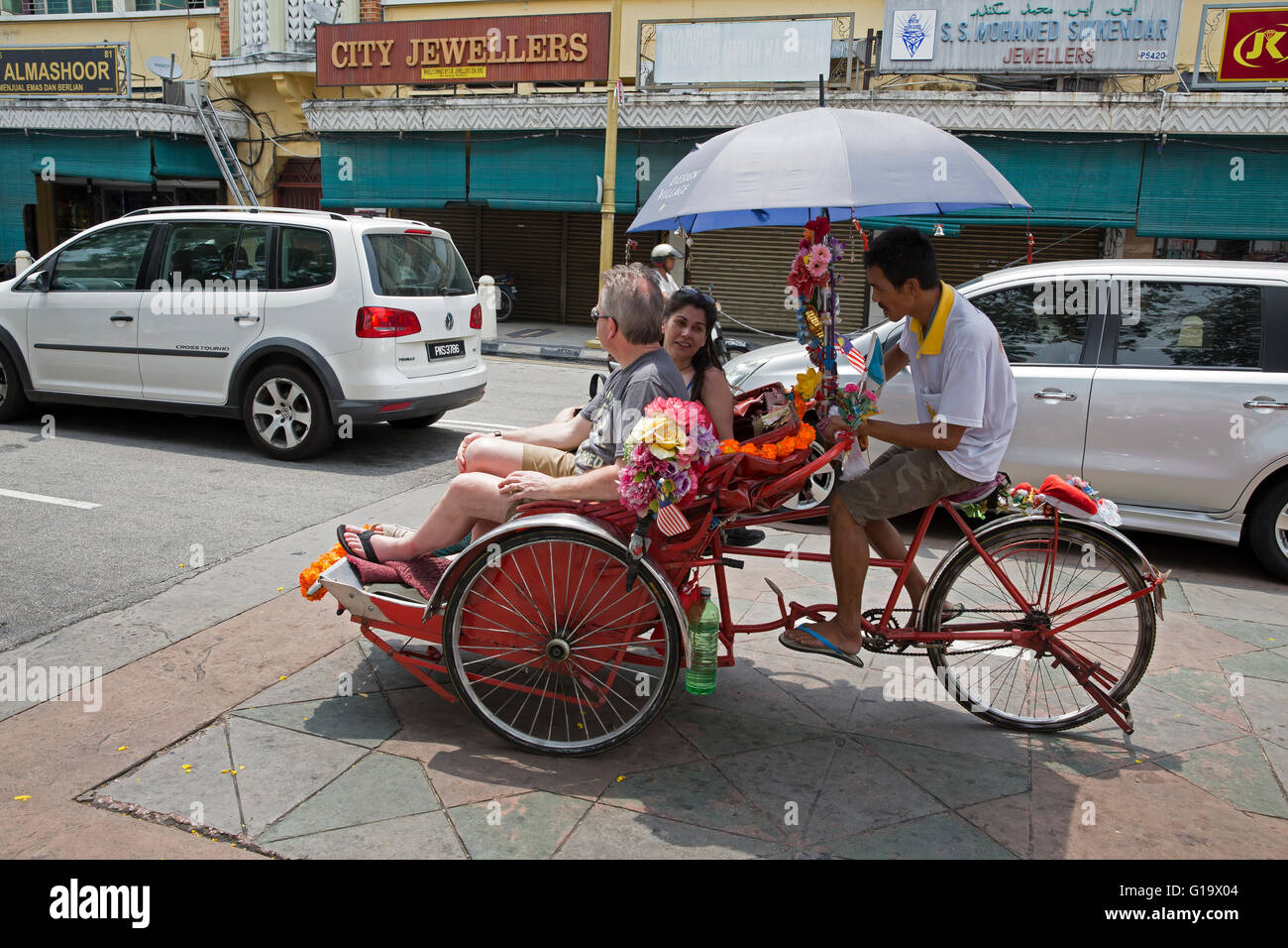 Taxi triciclo con un paraguas para dar sombra a los pasajeros del sol en  Penang, Malasia Fotografía de stock - Alamy