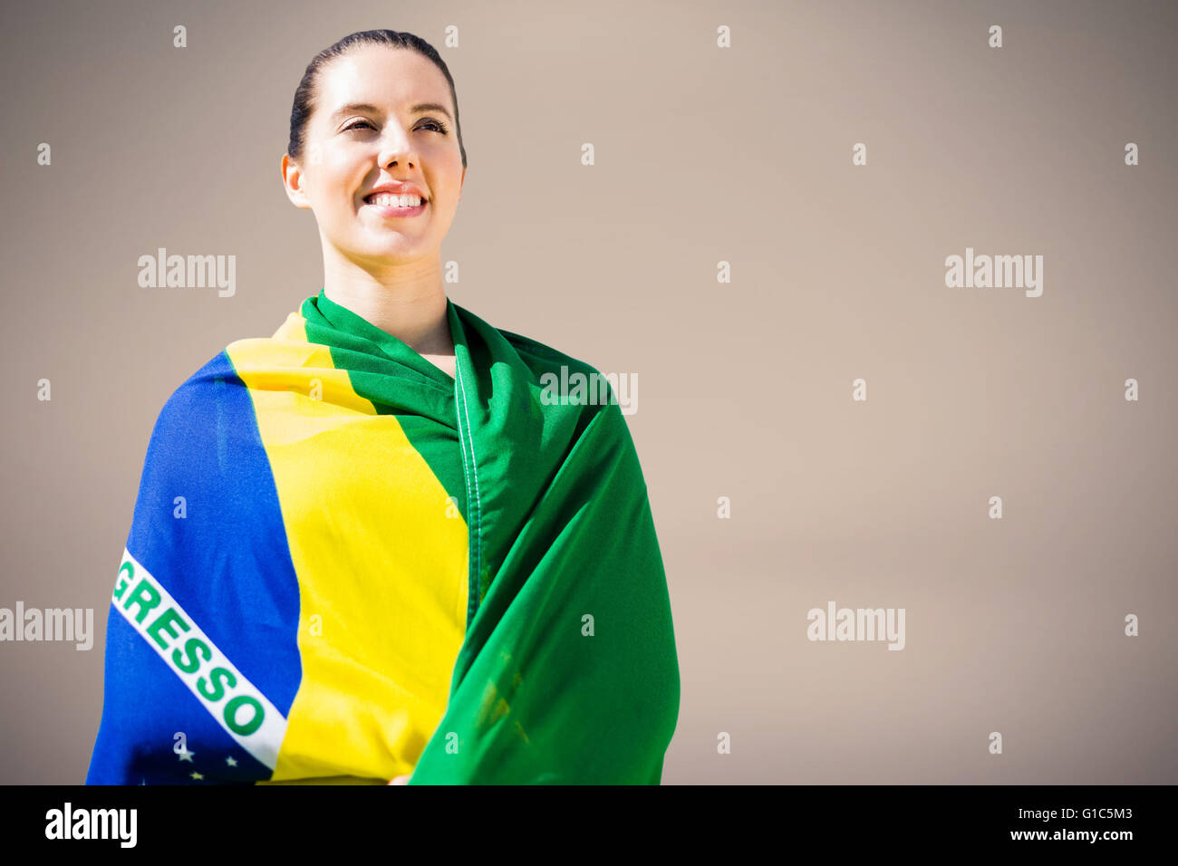 Imagen compuesta de mujer sosteniendo deportivo bandera brasileña Foto de stock