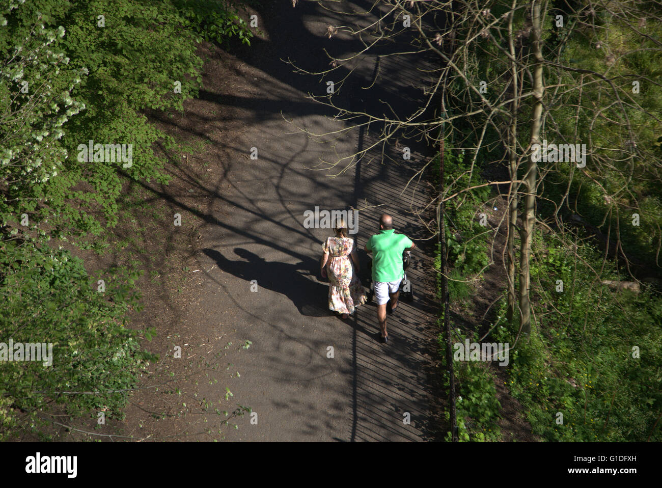 Par empujando cochecito mientras caminaba en el parque Kelvingrove disparó desde arriba, en un día soleado, parque Kelvingrove, Foto de stock