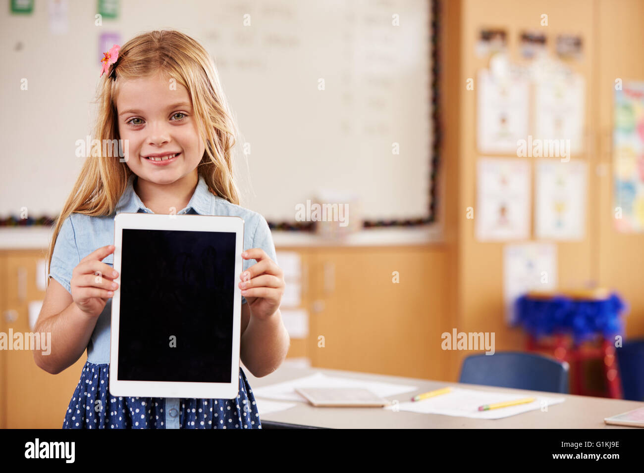 Niña de la escuela elemental sosteniendo un equipo tablet pc, Retrato Foto de stock