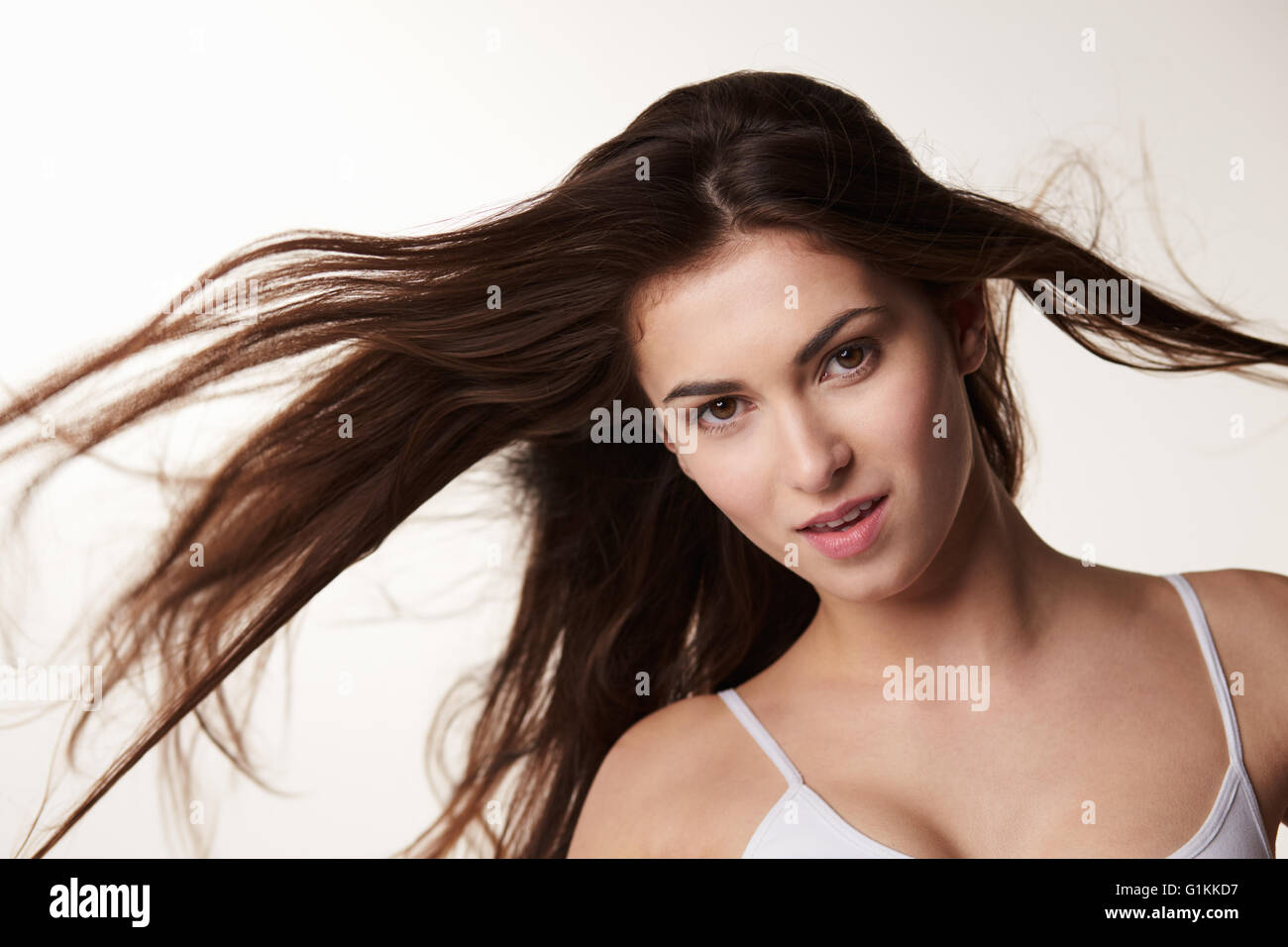 Morenaza, finales de jovencita con el pelo soplando, horizontal Foto de stock