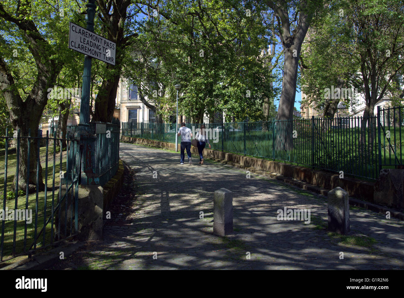 Pareja joven hombre y mujer caminando en la pintoresca localidad de Claremont pasar,Park Circus, Glasgow, Escocia, Reino Unido. Foto de stock