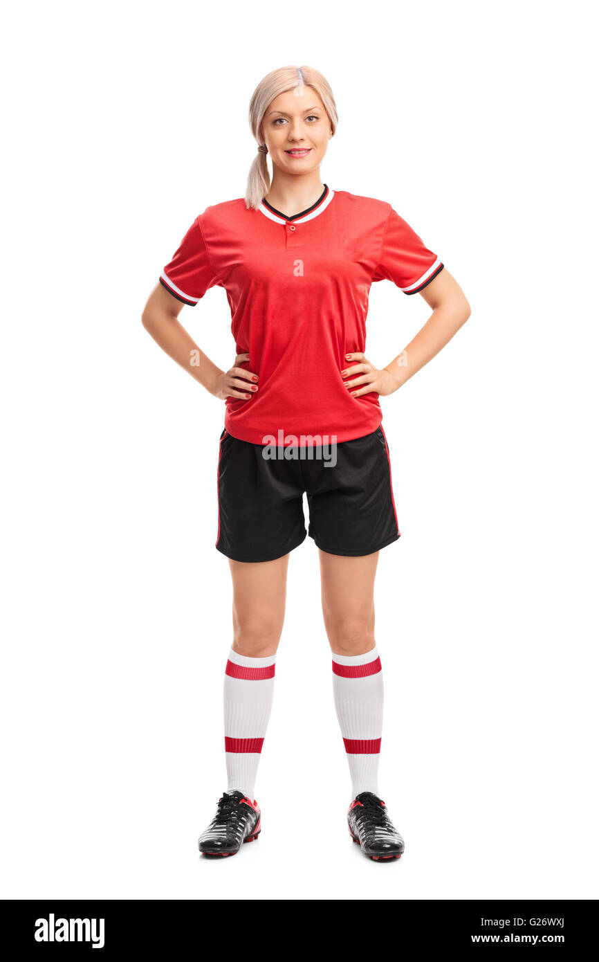 Longitud total retrato de un jugador de fútbol femenino profesional en un jersey rojo aislado sobre fondo blanco. Foto de stock
