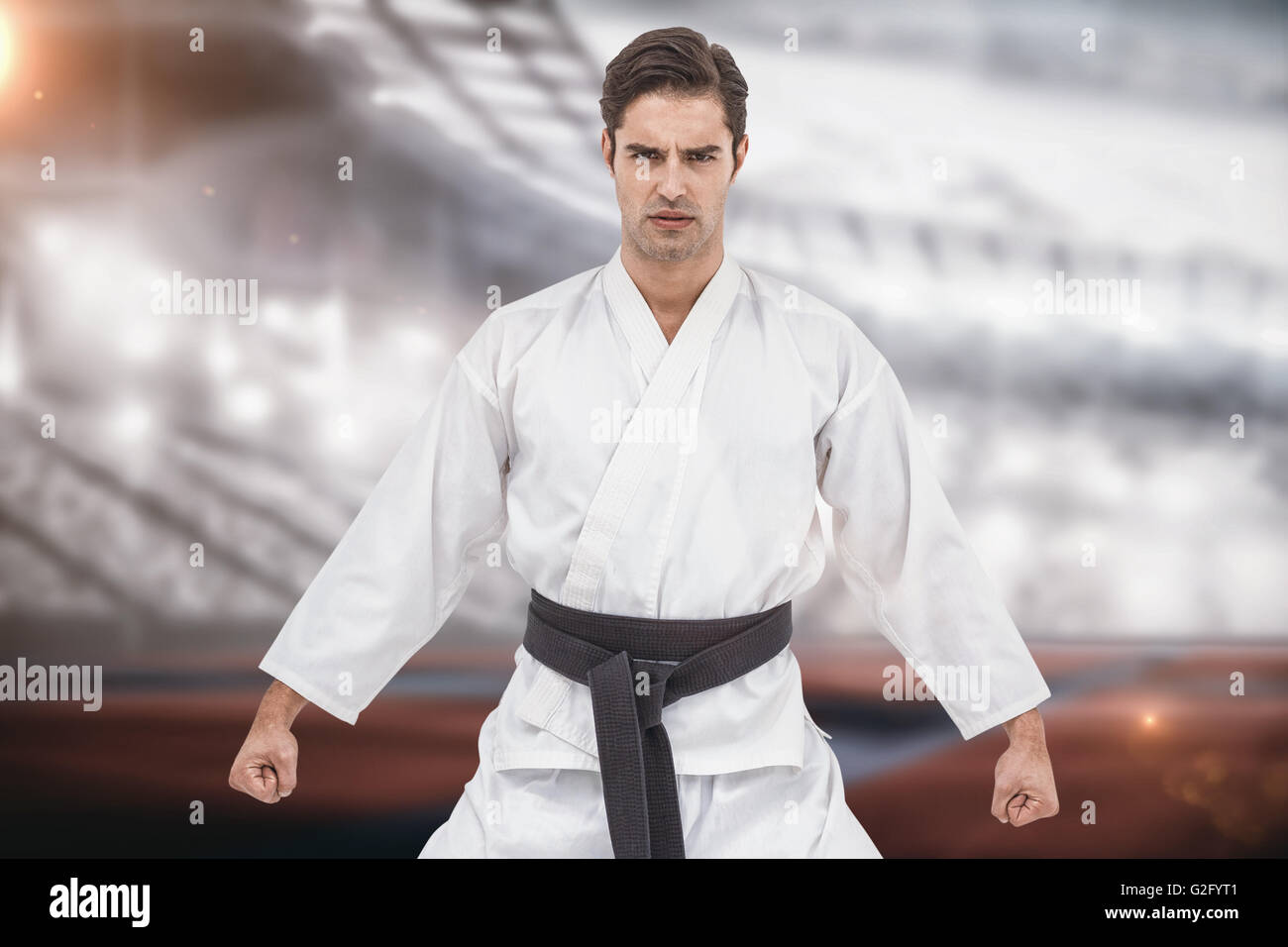 Imagen compuesta de retrato de graves jugador karate Foto de stock