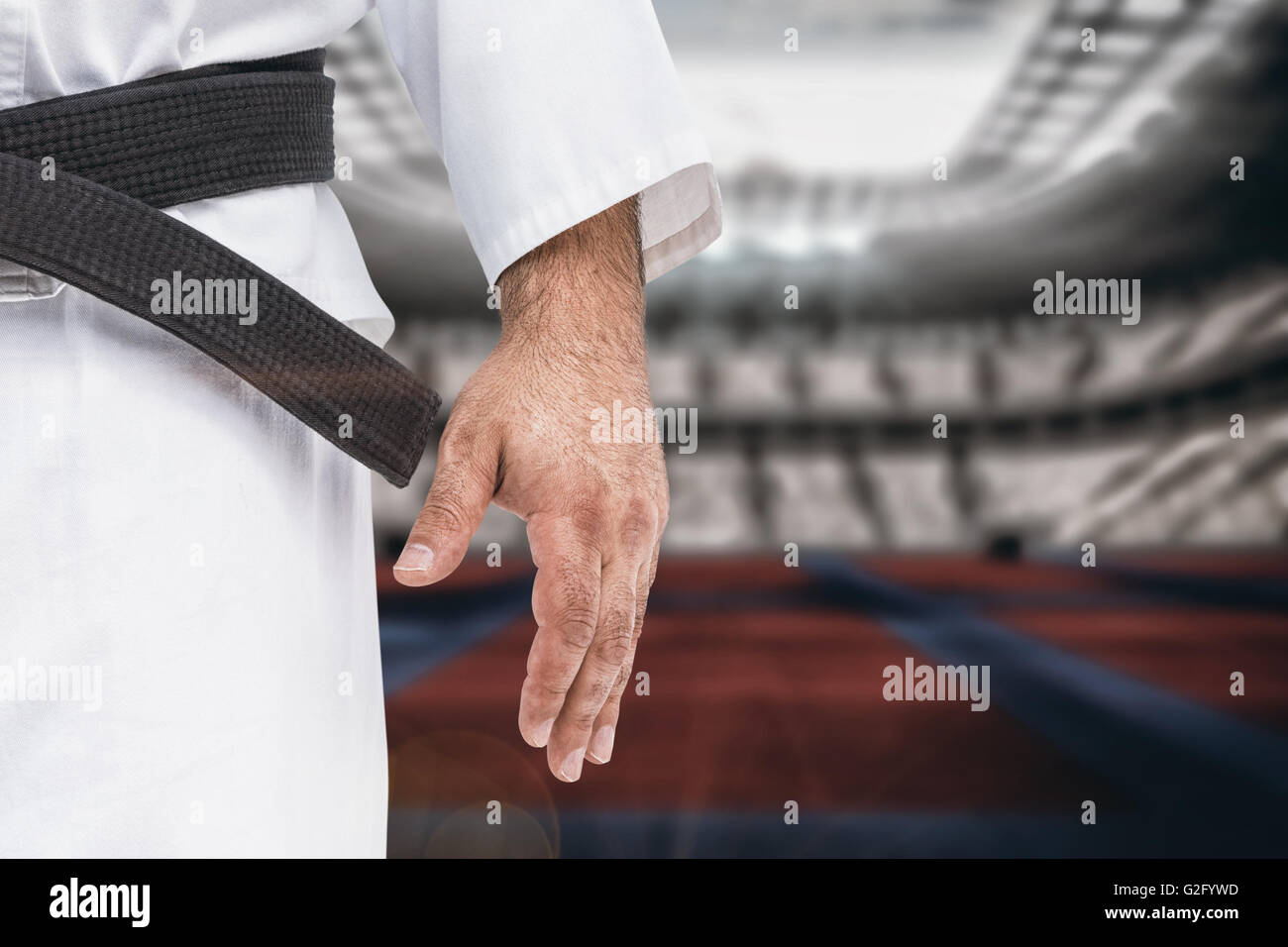 Imagen compuesta de close-up de karate cinturón negro sobre blanco uniforme Foto de stock