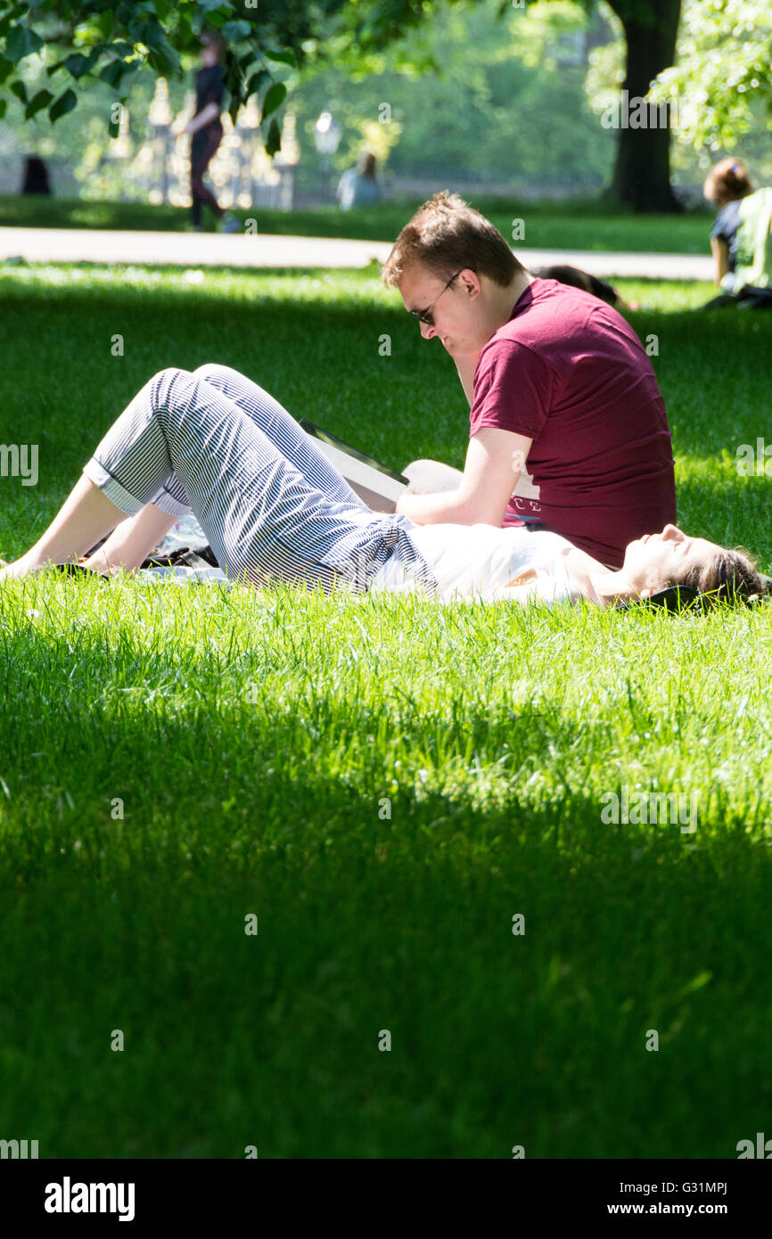Una pareja que se relaja en Hyde Park, City of Westminster, Londres, Inglaterra Foto de stock