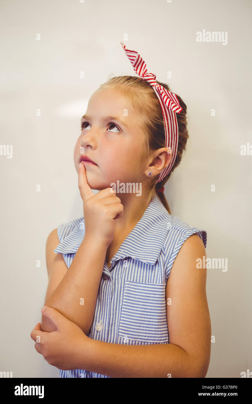 Pensativo linda chica con la mano en el mentón en el aula Foto de stock