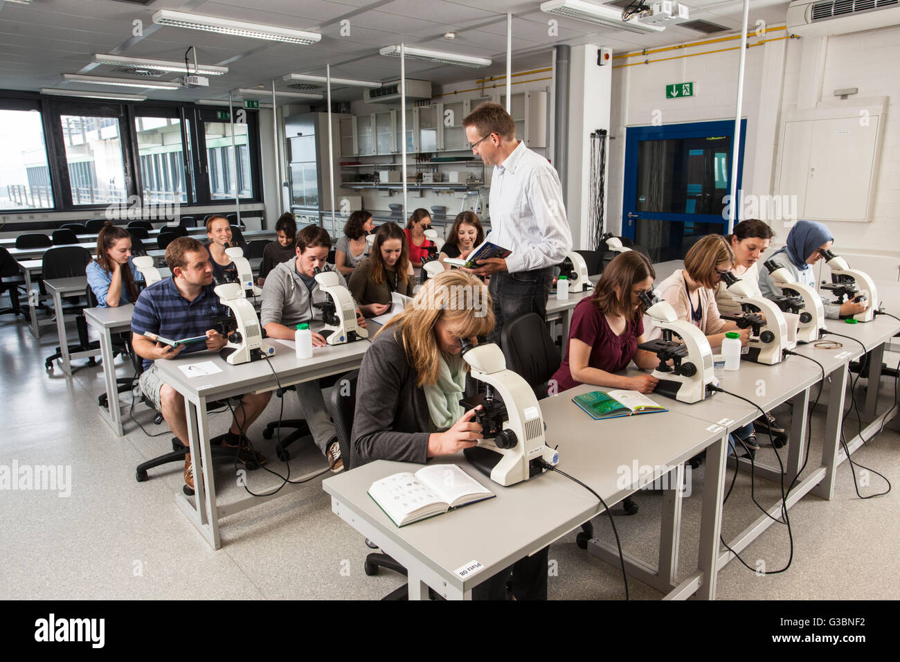 Los estudiantes en un curso de microscopía en la universidad debido Foto de stock