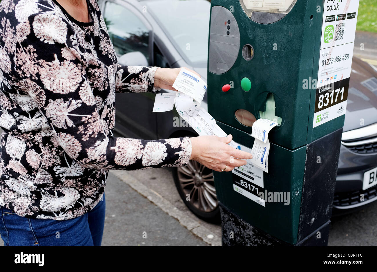 Parquímetros rotos en la ciudad de Brighton imprimir billetes inútiles con el frustrado automovilista hembra UK Foto de stock